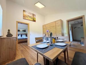 a dining room with a wooden table in a room at Apartment Maiskogel - directly on the ski slope in Kaprun