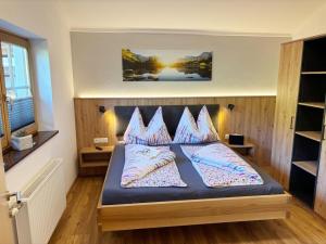 a bedroom with a bed with pillows on it at Apartment Maiskogel - directly on the ski slope in Kaprun