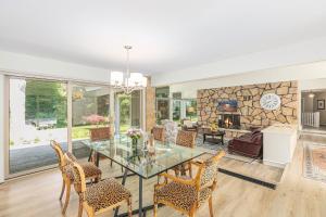a living room with a table and chairs and a fireplace at Bright 4BDR Home by Lake MI Arcadia Bluffs Portage Lake More in Arcadia