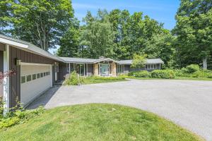 a house with a driveway and a garage at Bright 4BDR Home by Lake MI Arcadia Bluffs Portage Lake More in Arcadia