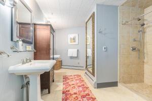 a bathroom with a sink and a shower and a mirror at Bright 4BDR Home by Lake MI Arcadia Bluffs Portage Lake More in Arcadia +29 photos
