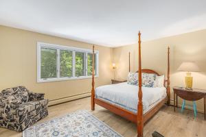 a bedroom with a bed and a chair and a window at Bright 4BDR Home by Lake MI Arcadia Bluffs Portage Lake More in Arcadia