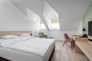 Postel nebo postele na pokoji v ubytování Hunguest Hotel Flóra