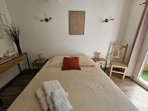 a bedroom with a bed with two towels on it at Chez Louis in Les Issambres +25 photos