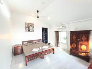 Postel nebo postele na pokoji v ubytování Marari Coco Villa + 19 fotografií