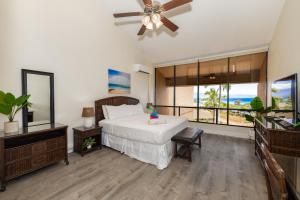 a bedroom with a bed and a ceiling fan at Oceanview Kahana Villa - Walk to Beach & Dining in Kahana +89 photos