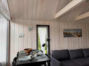 a living room with a couch and a table at HARMONY Slow Living Stay in Bigauņciems +10 photos
