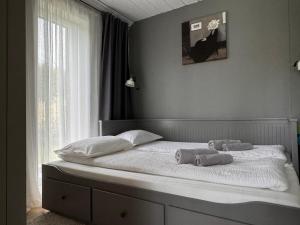 a bed with two towels on it with a window at HARMONY Slow Living Stay in Bigauņciems