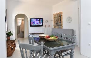 a kitchen and dining room with a table and chairs at Vagia Calm House in Parikia