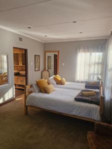 a large bedroom with two large beds with yellow pillows at Epicure Home Guesthouse in Heidelberg +68 photos