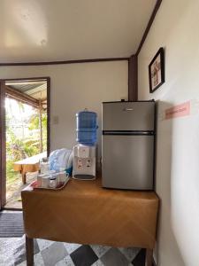 a counter with a refrigerator on top of a table at Camilas Payag in Inabanga