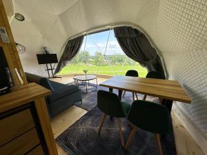 a room with a table and chairs and a window at Osada przy Szlaku Glamping Ojców in Wola Kalinowska