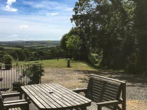 a wooden bench sitting in front of a field at Lower Shippen - 23493 in North Petherwin
