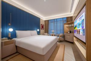 Jingdong Headquarters Crystal Orange Hotel, Yizhuang, Beijing房間的床