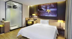 Postel nebo postele na pokoji v ubytování IU Hotel Tangshan Haigang Bus Station Branch