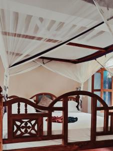 a bedroom with two beds with white sheets at Laguna Palace Resort in Michamvi