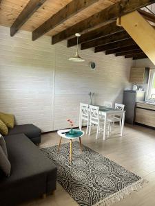 a living room with a couch and a table at "Morze Spokoju" domki letniskowe in Darlowko