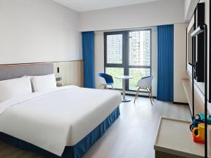 Ένα ή περισσότερα κρεβάτια σε δωμάτιο στο Holiday Inn Express Shanghai Putuo by IHG +48 φωτογραφίες