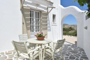 a white table and chairs on a patio at Vagia Calm House in Parikia