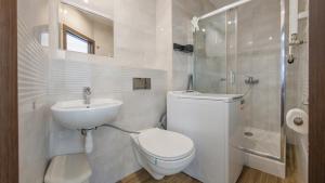 a bathroom with a toilet and a sink and a shower at Obrońców Wybrzeża, Sun & Snow in Puck