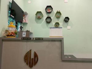 a wall with a shelf with clocks on it at ALOamarALO - Homely Comfort with a Touch of Luxury at Shantiniketan in Shānti Niketan