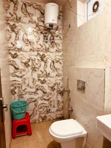 a bathroom with a toilet and a shower curtain at Hotel Wisteria Haridwar in Haridwār +46 photos