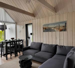 a living room with a couch and a table at HARMONY Slow Living Stay in Bigauņciems