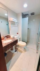 a bathroom with a toilet and a sink and a shower at Ming Garden Residence in Kota Kinabalu