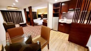 a hotel room with a bed and a living room at Ming Garden Residence in Kota Kinabalu