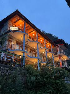 a large building is lit up at night at Cafekush tosh in Tosh