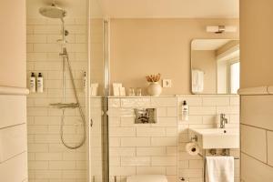 a bathroom with a shower and a toilet and a sink at Sola Strand Hotel in Sola +49 photos