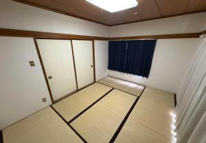 an empty room with white cabinets and a window at RHK Guest House102 in Tokyo +7 photos