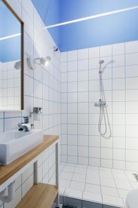 a bathroom with a shower, sink, and toilet at Avenue Hostel in Budapest