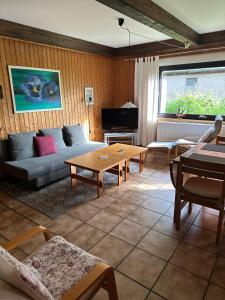 a living room with a couch and a table at Ferienwohnung An der Innerste in Wildemann