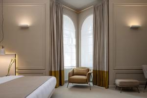 Ένα ή περισσότερα κρεβάτια σε δωμάτιο στο LUBICH Concept Hotel