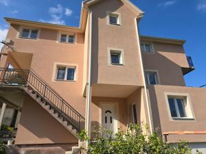 a large building with a staircase in front of it at Apartman Nadja2 in Tivat