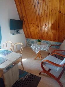 a living room with a table and chairs at Pokoje DAJAN in Łeba