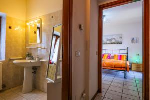 a bathroom with a sink and a bedroom with a bed at La Palma in Ghiffa +34 photos