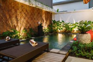 a pool in the middle of a building with plants at Dream House Ubud in Ubud