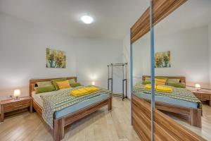Postel nebo postele na pokoji v ubytování Grad Inn Apartments & Resort
