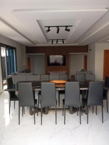 a dining room with a table and chairs and a couch at Luxury house in Martil in Martil +41 photos