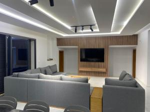 a living room with couches and a flat screen tv at Luxury house in Martil in Martil