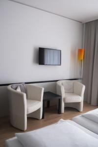 TV a/nebo společenská místnost v ubytování City-Hotel
