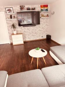 a living room with a couch and a table at Piotr House in Warrington