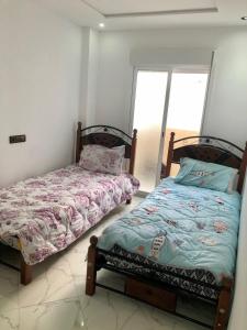 Ένα ή περισσότερα κρεβάτια σε δωμάτιο στο Appartement A Martil