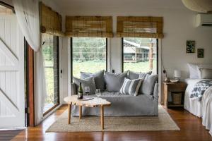 a living room with a couch and a table at Leaves & Fishes - Private group escape in the Hunter Valley in Lovedale