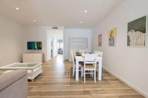 a white living room with a table and chairs at SOLGUEST Aparthotel Estepona in Estepona