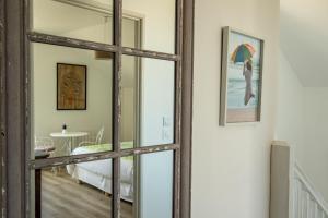 a large wooden mirror in a room with a bedroom at Coeur et Nature in Colembert