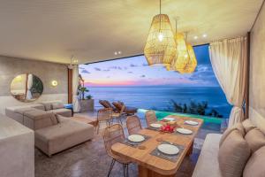 a living room with a view of the ocean at Blue Sarin Villa in Sampalan