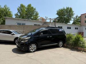 a black suv parked in a parking lot at Diplomat Noble Hotel in Ulaanbaatar